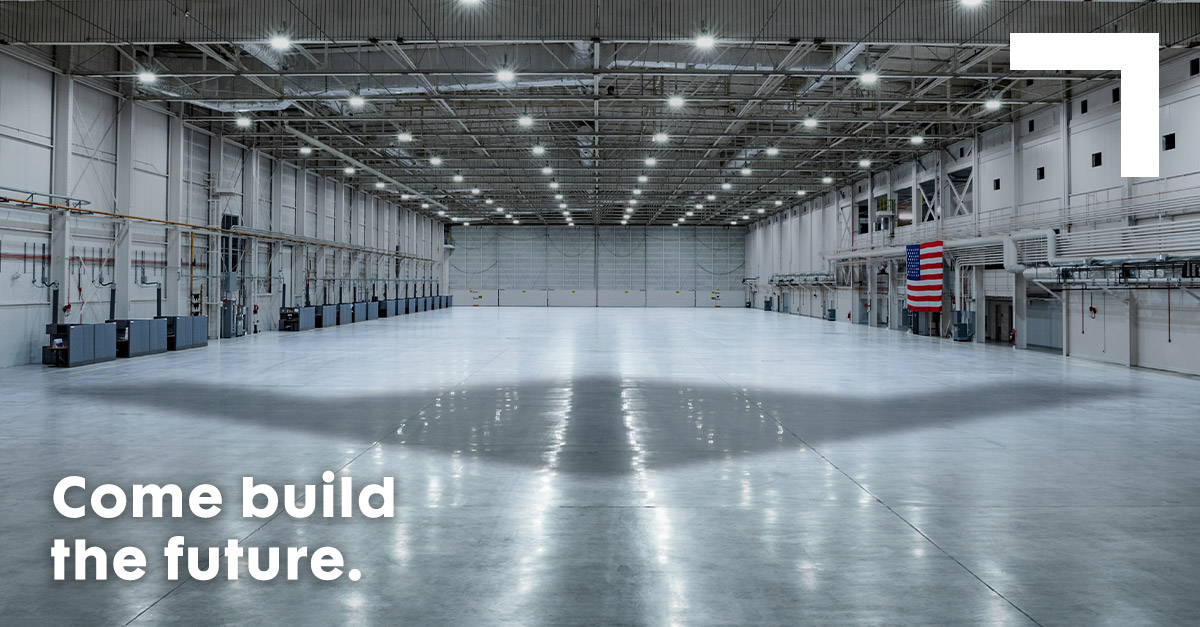 1200×627-Come-Build-The-Future shadow of bomber on floor of a hanger
