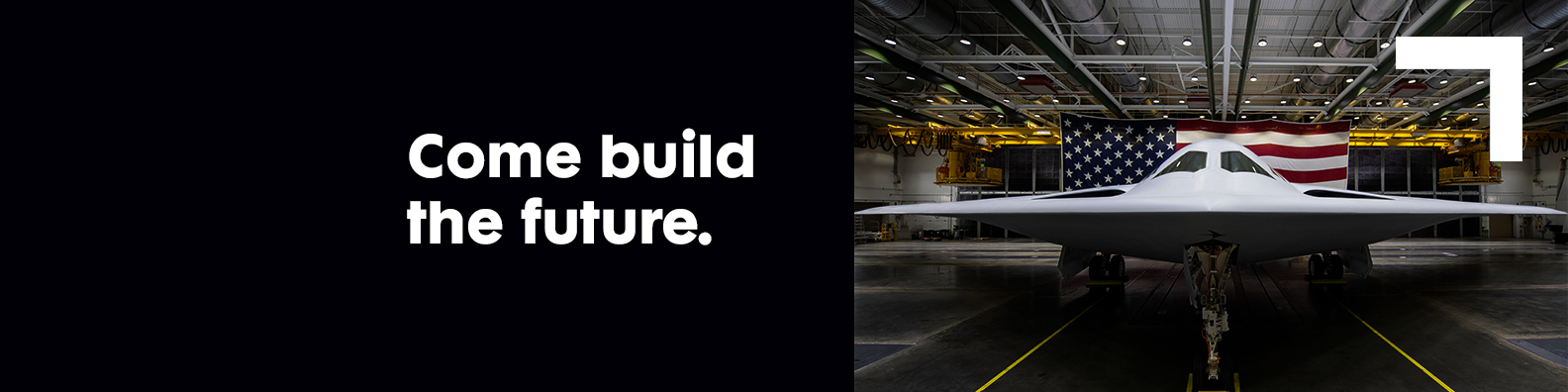 1584×396-Header-ComeBuildTheFuture front view of a bomber in a hanger