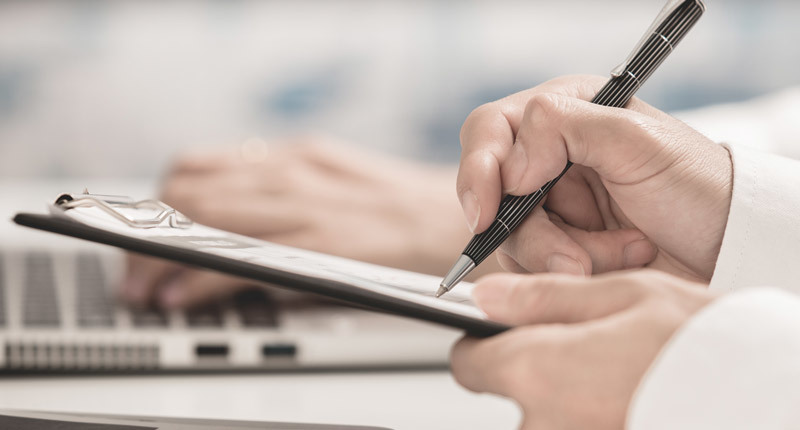 hand writing on clipboard Clearance Center Documents