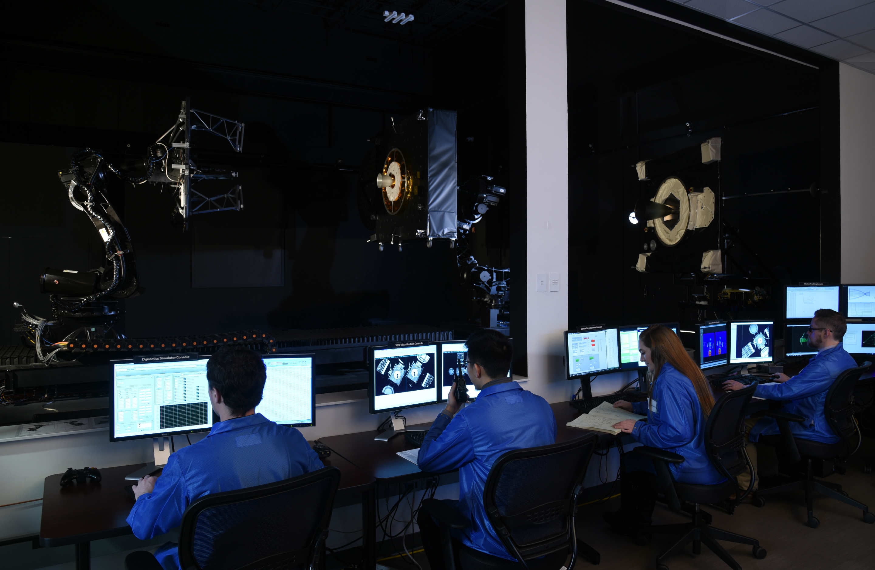 MEV Control Room technicians at computers in Mission Extension Vehicle control room