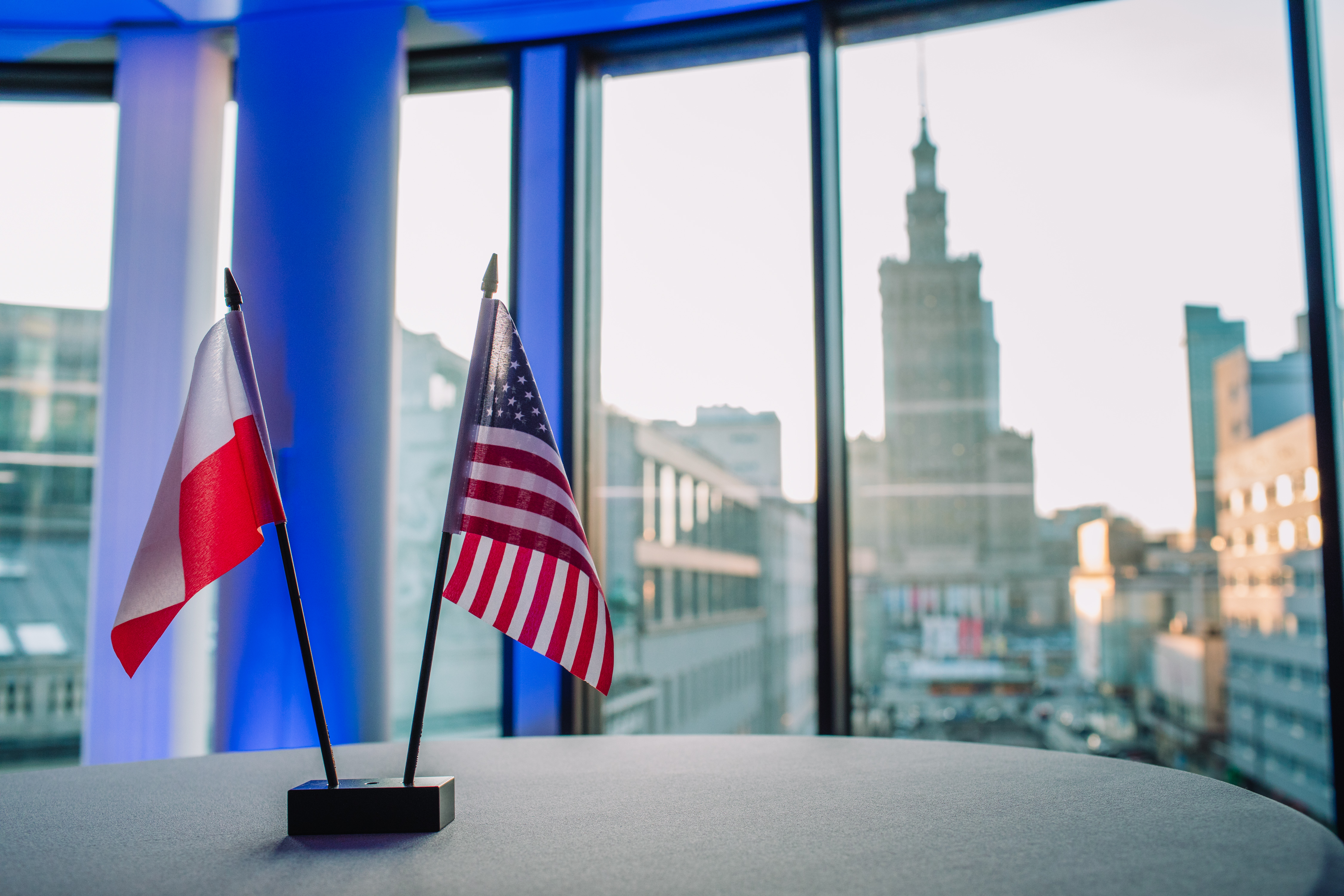 Flags on a Table Poland and US flags sitting on a desk.