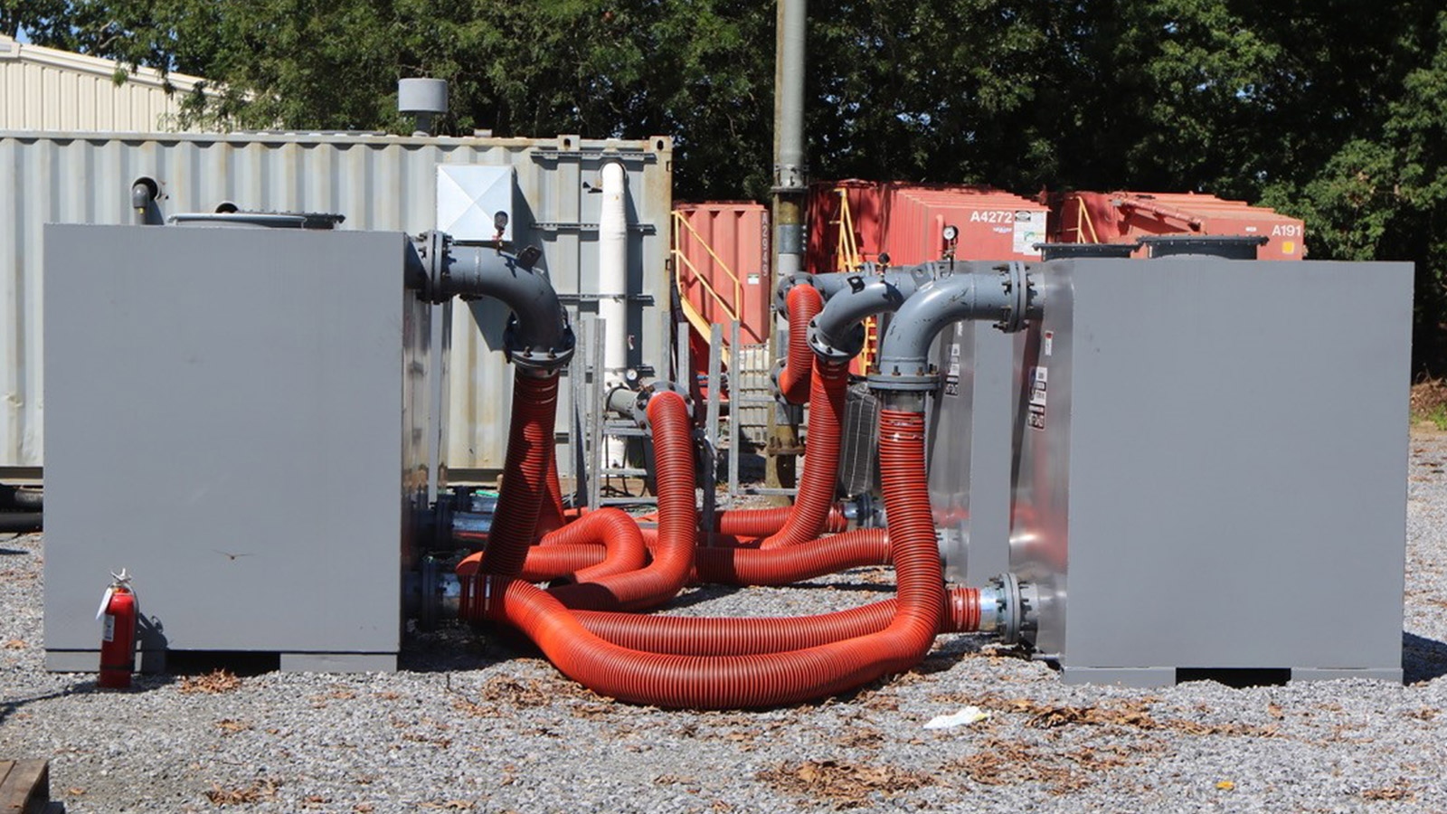 Bethpage Soil Cleanup Work Zone red pipes coming out of grey boxes