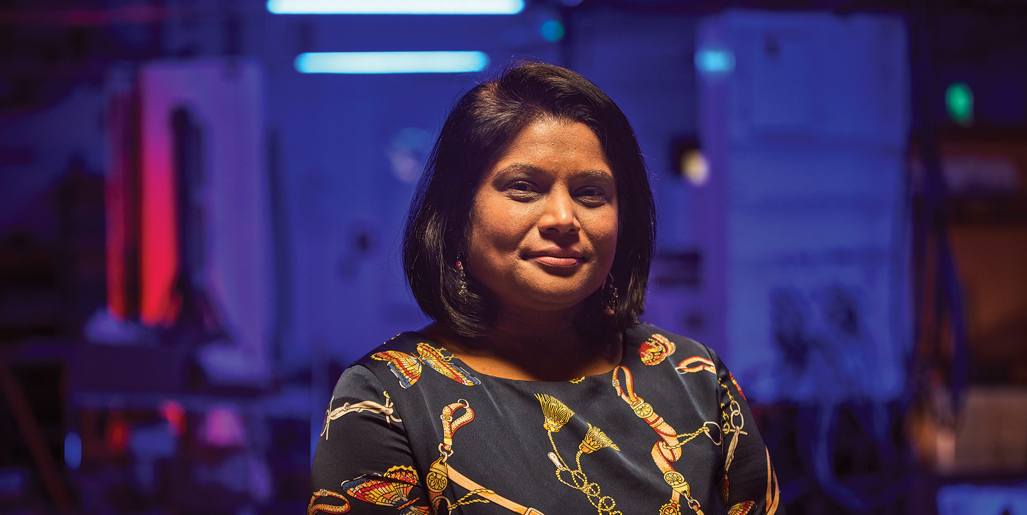 Gender Pay Gap Report – Women in Technology woman standing in room with blue background